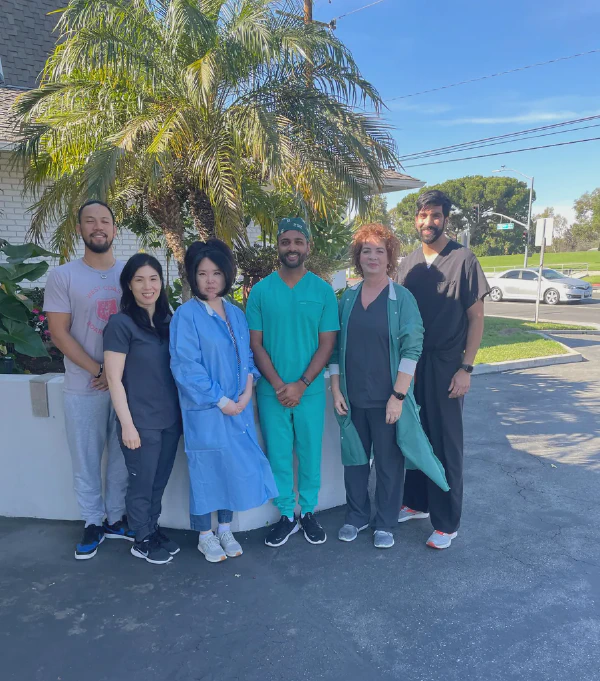 dr hirsh kaveeshvar and dr ashish shah with some of the local staff of synergexmed